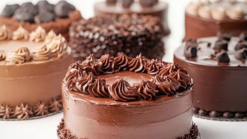 A variety of cakes decorated with chocolate frosting on a table, perfect for any occasion
