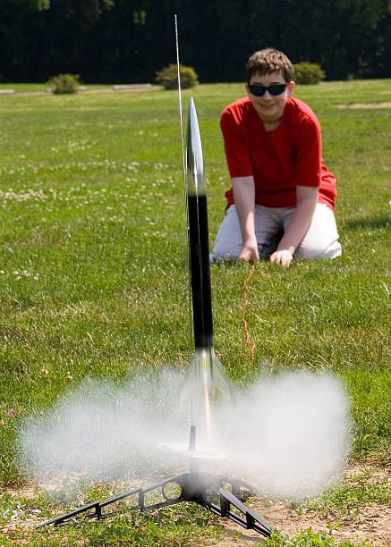 young kid preparing to launch a rocket - model rockets stock pictures, royalty-free photos & images