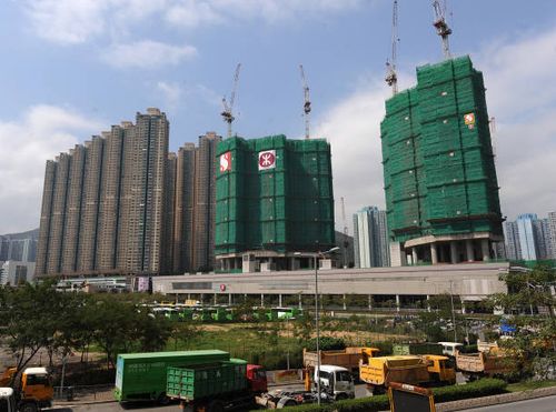 Vehicles pass a plot of land located in the Sai Kung district of the New Territories which recently sold at a land auction for 3.37 billion Hong Kong...