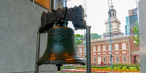 Liberty Bell inside with Independence Hall in the background