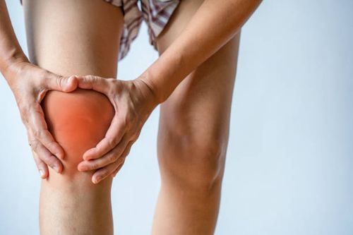 woman holding her painful knee on white background - osteoarthritis stock pictures, royalty-free photos & images