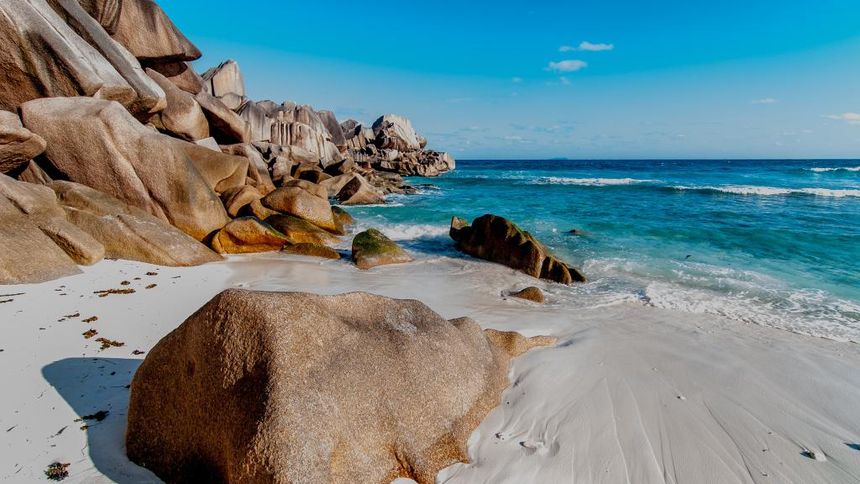White sandy beach with granite boulders