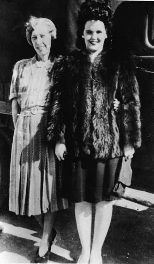 American aspiring actress and murder victim Elizabeth Short , known as the 'Black Dahlia,' wears a fur coat and stands with her mother, Phoebe Mae...