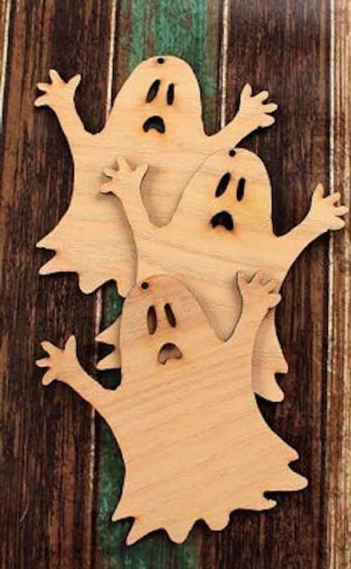 a wooden cutout of two ghost faces