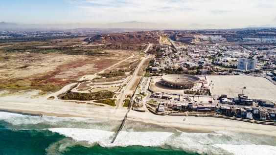 A drone shot look at the San Diego-Tijuana border from the pacific direction.