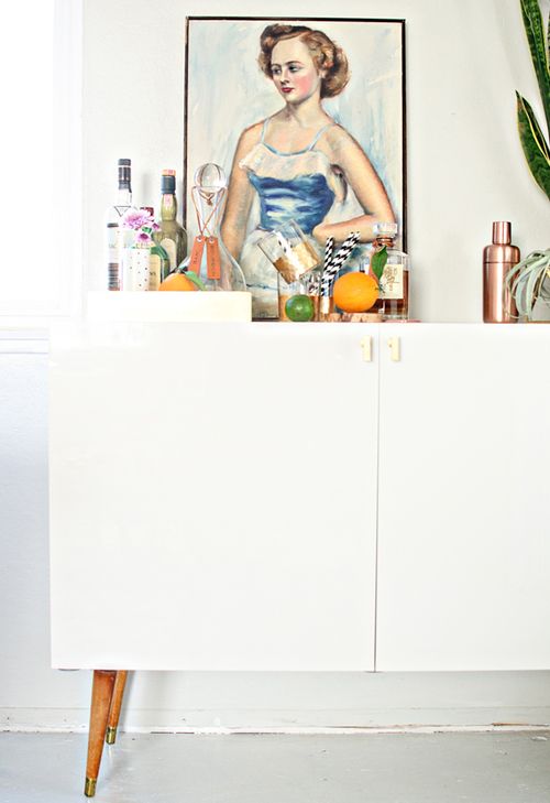 This Mid Century Modern Bar Cabinet from IKEA was upgraded with some thrifted furniture legs