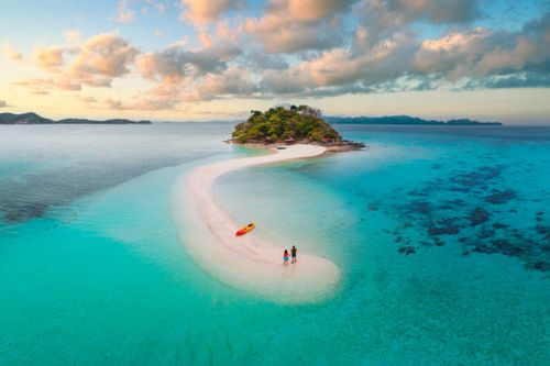 couple on idyllic tropical sandbar at sunset - couple ocean stock pictures, royalty-free photos & images