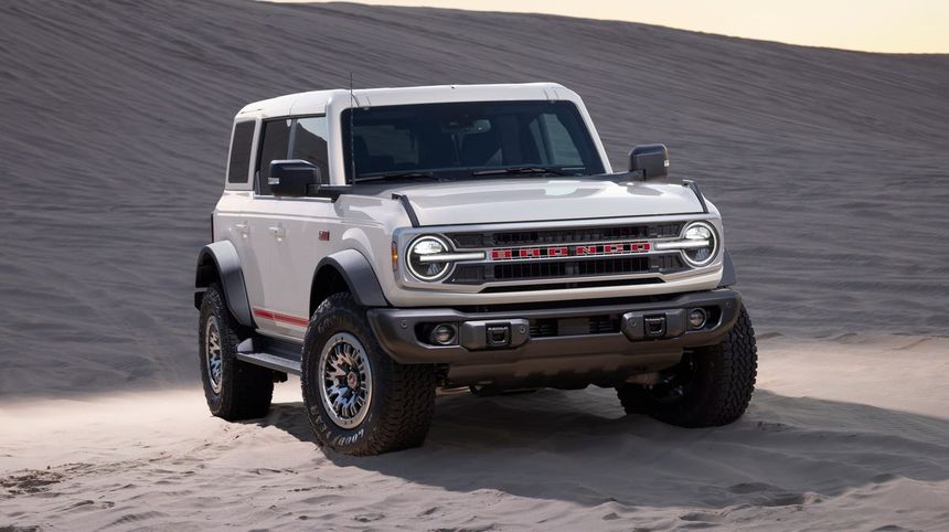 Ford Bronco off-road SUV driving on sand dunes showcasing rugged capability