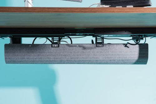 Closeup shot of the Uplift V3 Standing Desk's cable management tray.