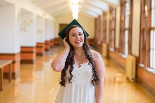 University graduate on her college campus in a cap and gown celebrating graduating from her undergrad bachelor`s degree during the Spring. Bachelor s degree stock images, royalty-free photos and pictures