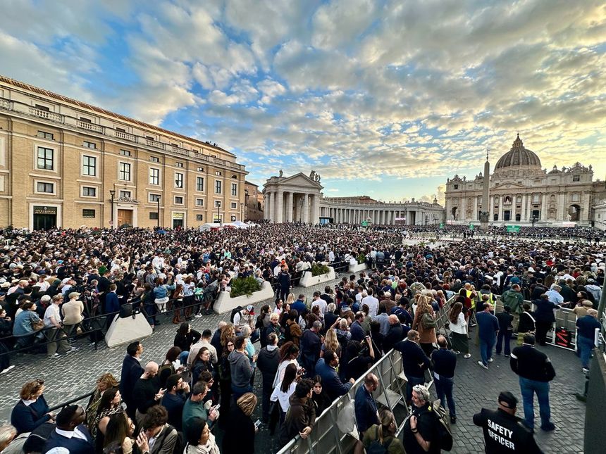 People gather to watch during the conclave on Wednesday.