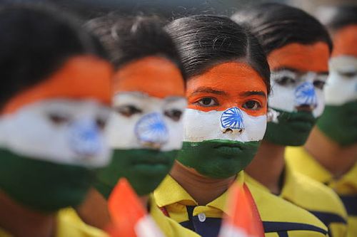 Indian school students wearing facepaint depicting the national flag take part in an event to mark Republic Day in Chennai on January 25, 2017. - The...