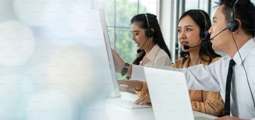 Business team wearing headset working actively in office . Call center, telemarketing, customer support agent provide service on telephone video conference call.