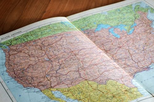 Free High-angle view of a vintage map depicting the United States with intricate details. Stock Photo