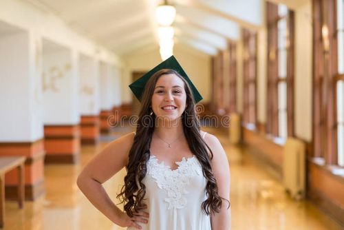 University graduate on her college campus in a cap and gown celebrating graduating from her undergrad bachelor`s degree during the Spring. Bachelor s degree stock images, royalty-free photos and pictures