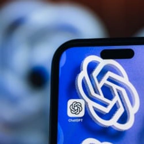 chatgpt app on phone screen with openai logo in background