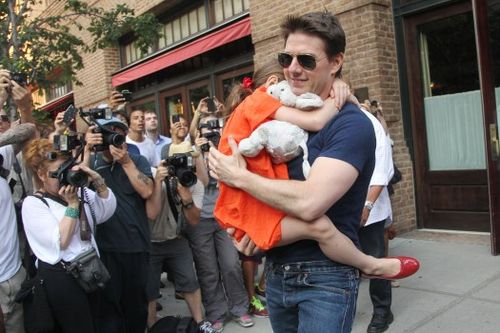 US actor Tom Cruise leaves his hotel  carrying daughter Suri for her  gymnastics class  on July 17, 2012 in New York, NY.   (MEHDI TAAMALLAH/AFP/GettyImages)