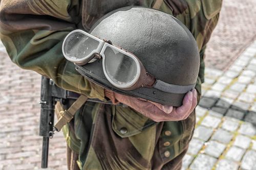 person dressed as a soldier holds a motorcycle helmet with goggles - world war 2 holland stock pictures, royalty-free photos & images