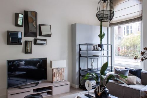 A TV on a grey TV stand in a modern living room