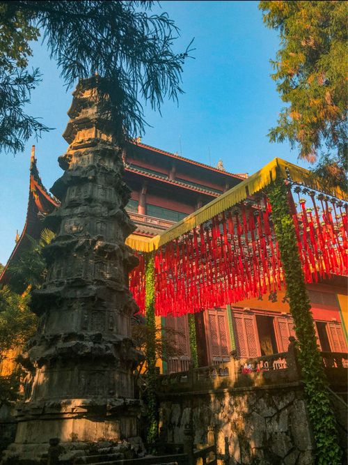 Intricate carvings and statues at Lingyin Temple's halls