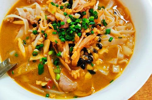 Locals enjoying Laoyou Noodles in a traditional setting