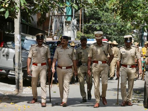 Guardians of Peace: Indian Police Patrolling Public Areas Wallpaper