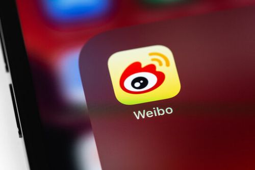Sina Weibo mobile app icon on a screen smartphone closeup. Sina Weibo - Chinese microblogging service. Batumi, Georgia - August 12, 2023