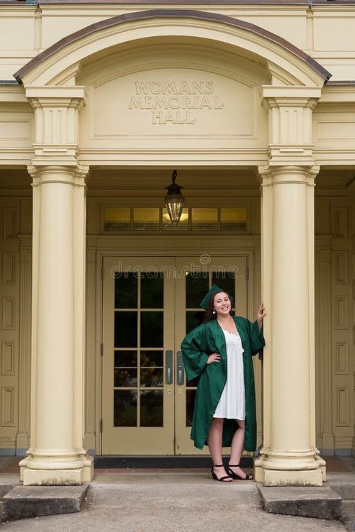 University graduate on her college campus in a cap and gown celebrating graduating from her undergrad bachelor`s degree during the Spring. Bachelor s degree stock images, royalty-free photos and pictures