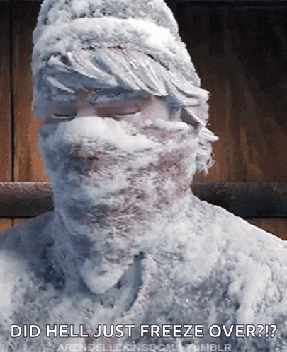A Man Covered In Snow With The Words Did Hell Just Freeze Over Written Below Him GIF