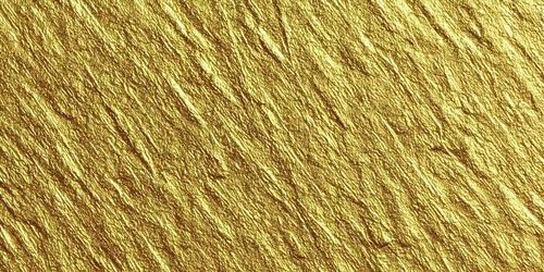 A close up view of a shimmering gold metallic crumpled texture with diagonal lines photo
