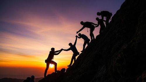 The Power of Collaboration Silhouettes of Climbers Helping Each Other Reach the Summit at Sunset photo