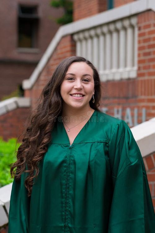 University graduate on her college campus in a cap and gown celebrating graduating from her undergrad bachelor`s degree during the Spring. Bachelor s degree stock images, royalty-free photos and pictures