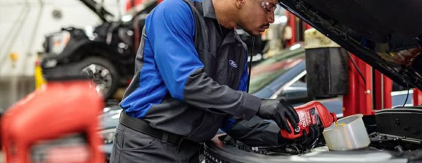 Ford technician performing oil change service at Irvine Ford service center
