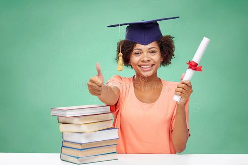 Education, school, graduation, gesture and people concept - happy smiling african american student girl in bachelor cap with books and diploma showing thumbs up over green chalk board background. Bachelor degree stock images, royalty-free photos and pictures