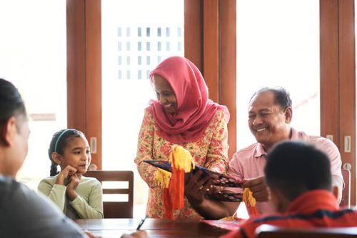 family making wau bulan for festival at home - making wau stock pictures, royalty-free photos & images