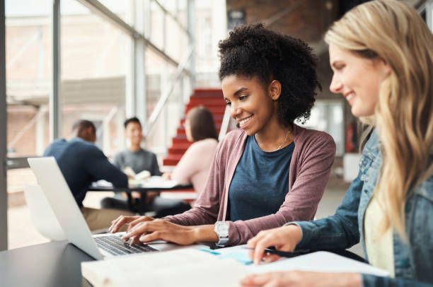 university student, friends and study on campus laptop, research and education test, exam books and course project. young college students women learning online, technology and knowledge in cafeteria - online course stock pictures, royalty-free photos & images