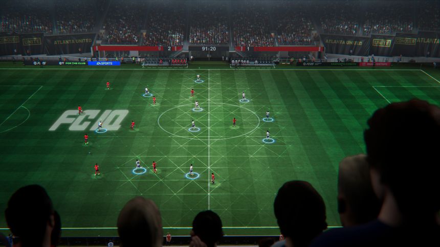 Aerial view of an illuminated modern stadium at night with a soccer match in progress.