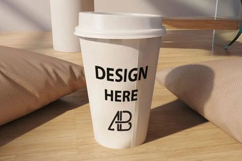 Coffee Cup Beside Two Pillows Mockup FREE PSD