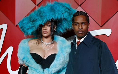 Barbadian singer Rihanna and US rapper Asap Rocky pose on the red carpet upon arrival at The 2024 Fa...
