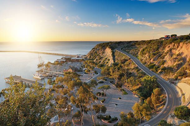 Scenic coastal road overlooking Dana Point Harbor during sunset in Orange County