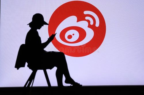 NEW YORK, USA, 25. MAY 2020: Sina Weibo Chinese microblogging website Young woman silhouette sitting on chair and playing on her smartphone. Company logo on screen in background. Weibo app stock images, royalty-free photos and pictures