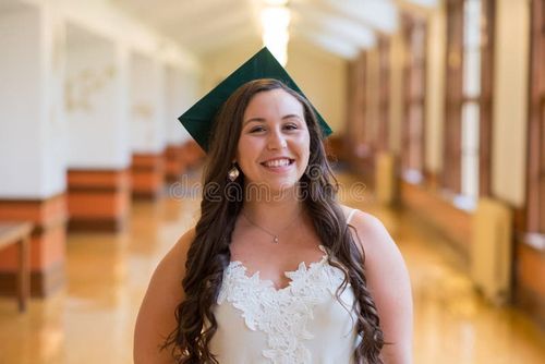 University graduate on her college campus in a cap and gown celebrating graduating from her undergrad bachelor`s degree during the Spring. Bachelor s degree stock images, royalty-free photos and pictures
