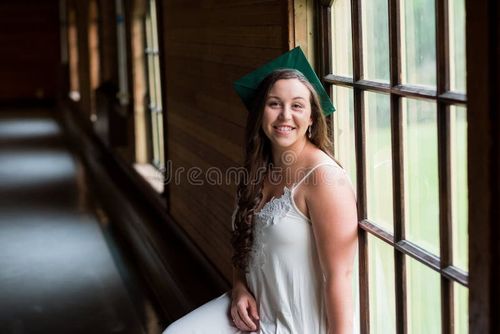 University graduate on her college campus in a cap and gown celebrating graduating from her undergrad bachelor`s degree during the Spring. Bachelor s degree stock images, royalty-free photos and pictures