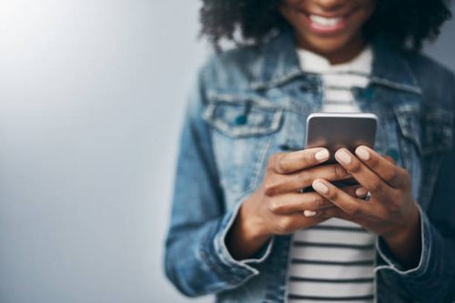 She loves being connected Studio shot of an unrecognizable young woman using her cellphone against a grey background she stock pictures, royalty-free photos & images