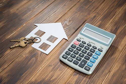 Mortgage Calculator, house and key with Calculator house and key with Calculator on wooden background mortgage calculator stock pictures, royalty-free photos & images