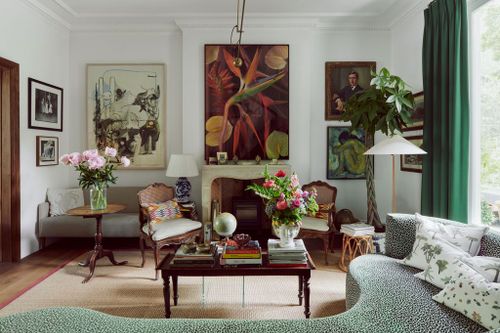 Image may contain Living Room Room Indoors Furniture Interior Design Couch Plant Rug Human Person and Flower