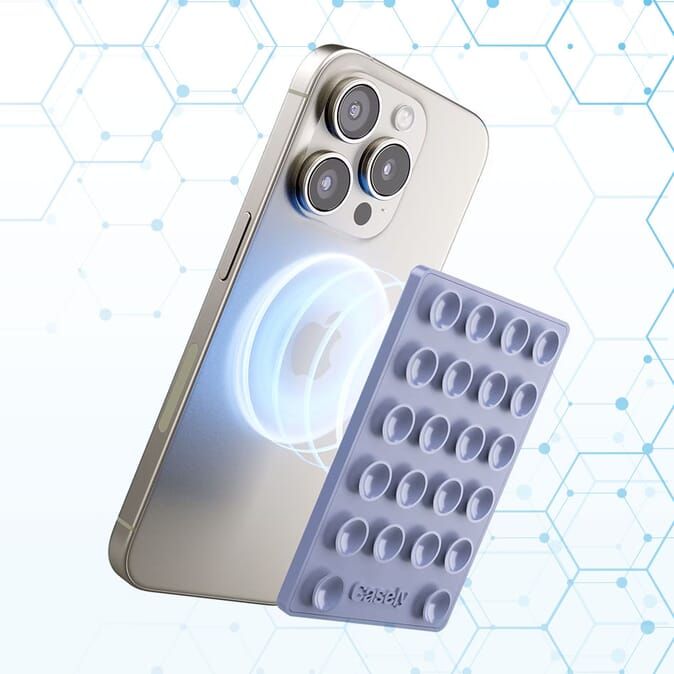 A smartphone charging wirelessly on a sleek charging pad.