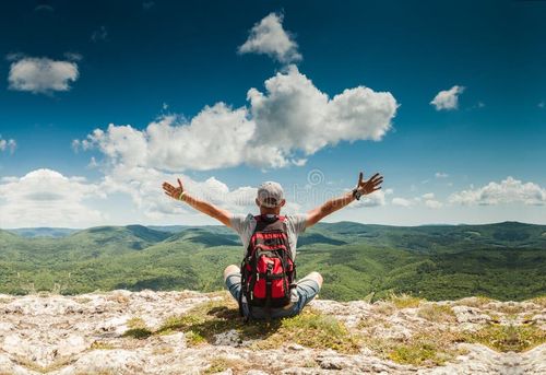 Man greeting amazing rich nature on the top of mountain. Nature stock images, royalty-free photos and pictures