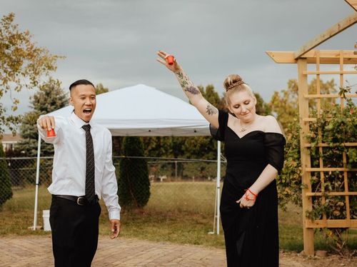 Cute Couple Poses: Couple raises their glasses in a toast.