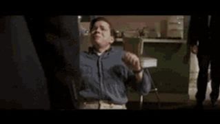 two men in suits and ties are standing next to each other in a room .